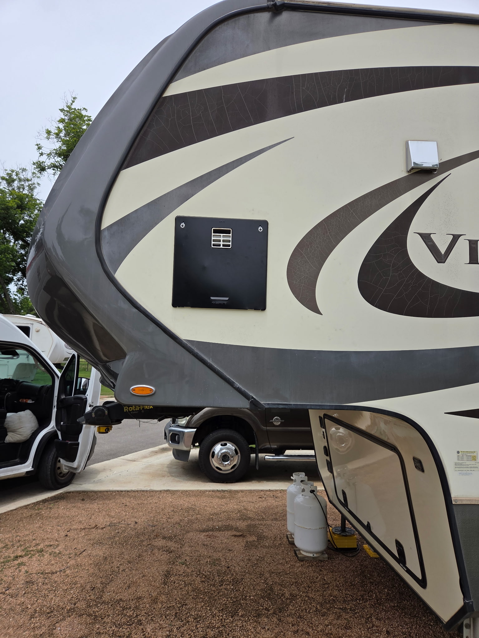 Fifth wheel exterior with water heater panel closed after repair