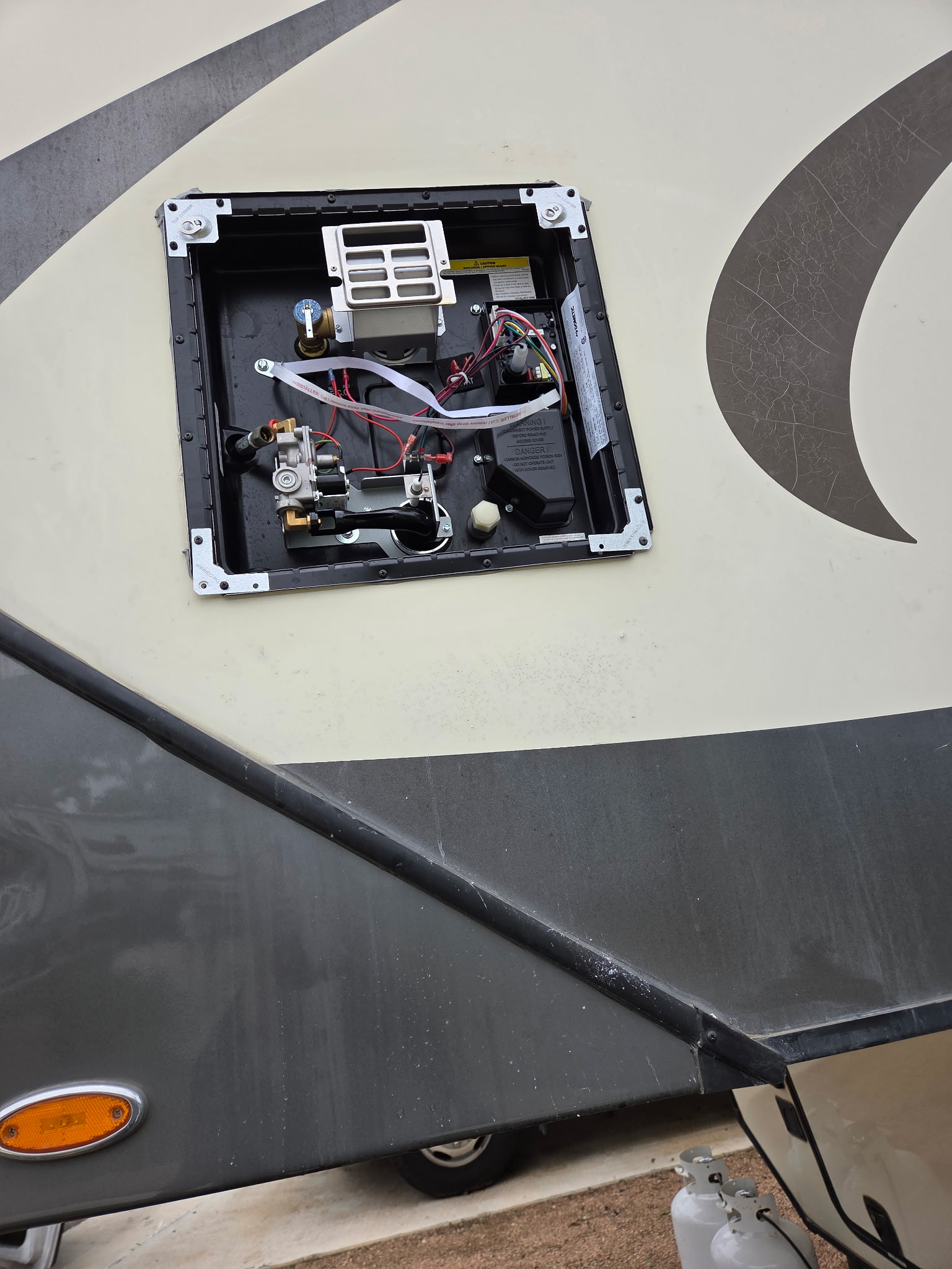 Fifth wheel water heater panel open showing clean internals